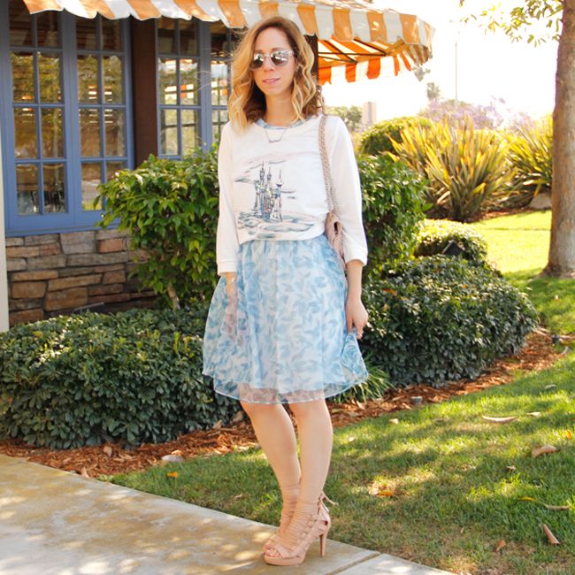 Fashion blogger The Key To Chic wears a LC Lauren Conrad for Kohl's Disney Cinderella collection sequin castle graphic sweatshirt and organza bow back dress.