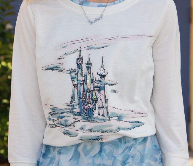 Fashion blogger The Key To Chic wears a LC Lauren Conrad for Kohl's Disney Cinderella collection castle graphic sweatshirt and organza bow back dress.