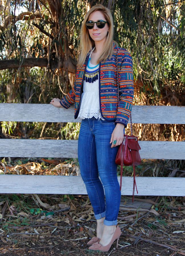 LA fashion blogger The Key To Chic wears a tassel necklace, quilted Forever 21 jacket, peplum lace top, Boohoo Laila bow heels, Old Navy Rock star skinny jeans, Rebecca Minkoff Swing bag, and Warby Parker Quimby Sunglasses