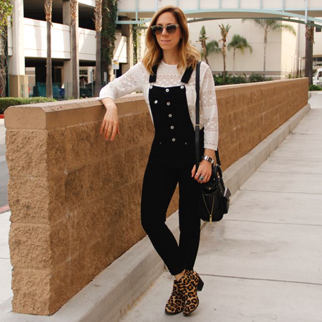 Fashion blogger The Key To Chic wears a white lace blouse with black overalls and Topshop leopard print ankle boots.