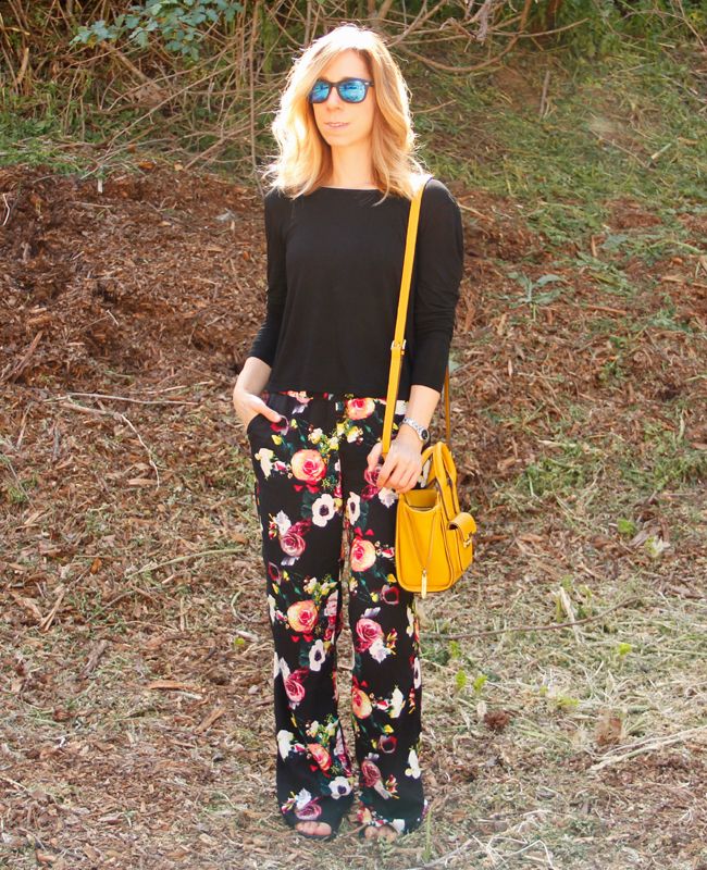 Fashion blogger The Key To Chic wears a twist back top, cage sports bra, Merona floral pants, and Sam & Libby Arianna gladiator sandals.
