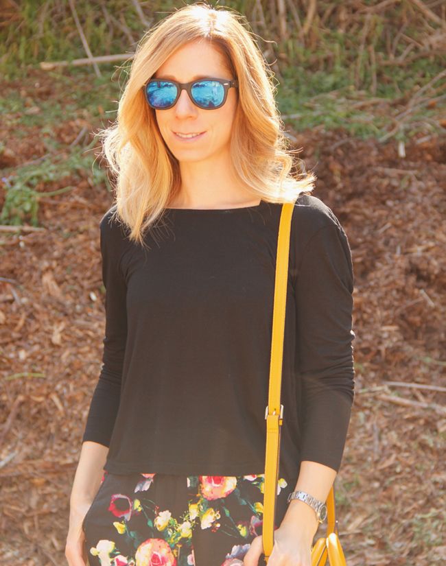 Fashion blogger The Key To Chic wears a twist back top, Forever 21 strappy cage sports bra, and Merona floral pants
