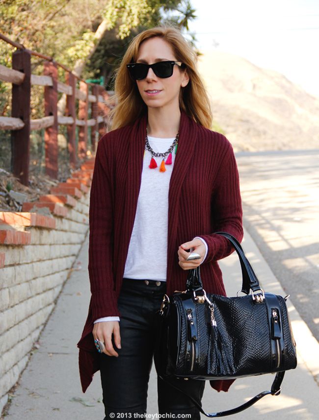 L.A. fashion blogger The Key To Chic wears an Isabel Marant for H&M white T-shirt and black waxed biker jeans with a Mellow World handbag, Charlotte Russe waterfall cardigan, and Topshop leopard boots