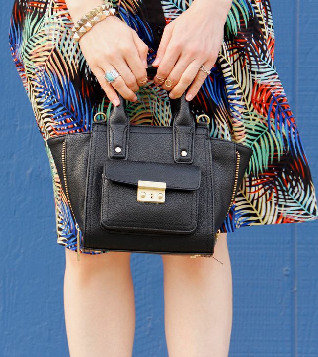 L.A. fashion blogger The Key To Chic wears a matching tropical print crop top and skirt from Sense of Style boutique with ankle strap heels and a Phillip Lim for Target mini satchel.