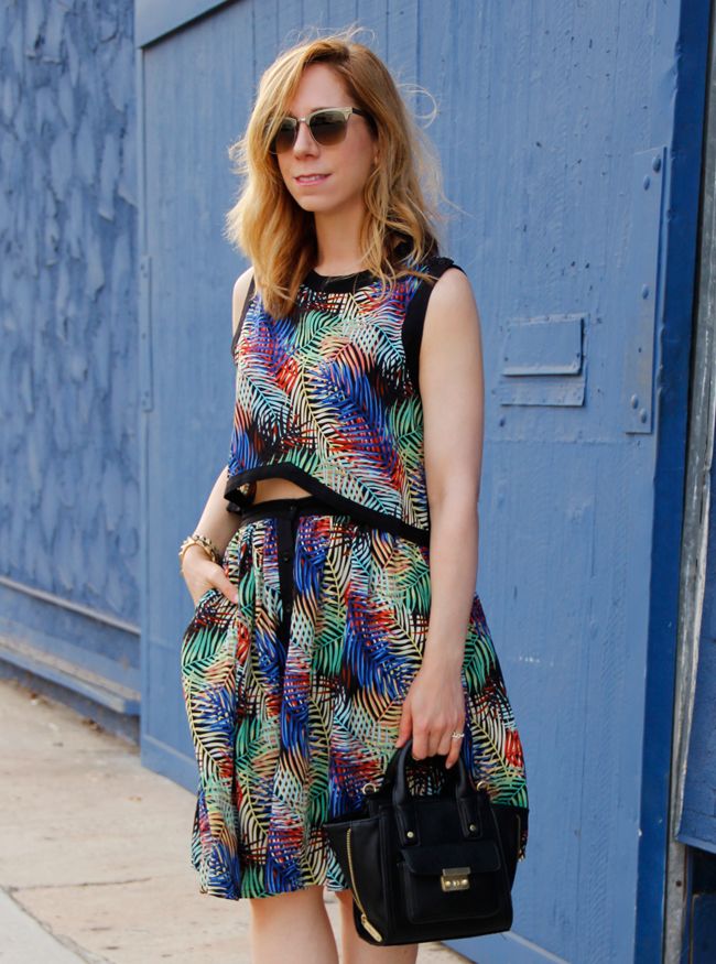 L.A. fashion blogger The Key To Chic wears a matching tropical print crop top and skirt from Sense of Style boutique with ankle strap heels and a Phillip Lim for Target mini satchel.